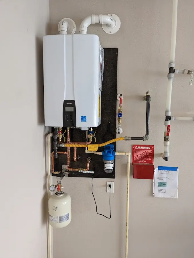 Professional plumber installing copper piping in a Lynchburg, Moore County home